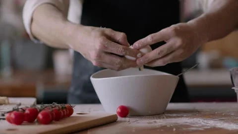Chef male hands separation egg white from yolk in slow motion. separation Stock Footage 261137636