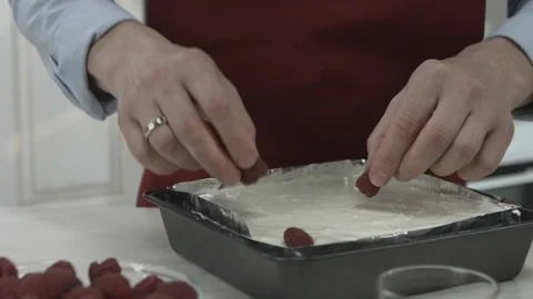Chef Man Baker Putting Raspberries on Cake Top Stock Footage 160977702