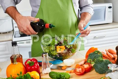 Chef man cooking in the kitchen. Stock Photos