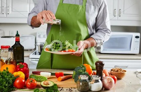 Chef man cooking in the kitchen. Stock Photos