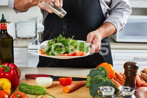 Chef man cooking in the kitchen. Stock Photos