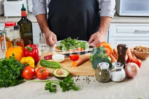Chef man cooking in the kitchen. Stock Photos
