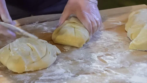 Chef man cuts dough with a baking knife close-up Stock Footage 106525556