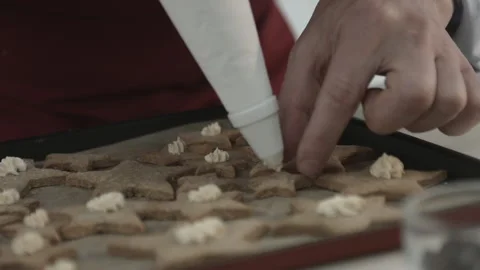 Chef Man Decorating Cookies Top with Tasty Cream Stock Footage 165497778