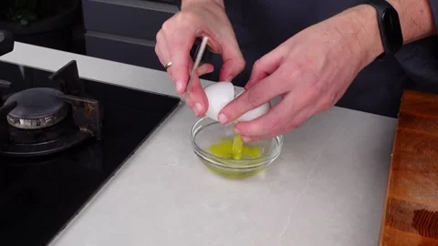 Chef man hands break eggs into a bowl for whisking eggs Stock Footage 260233582
