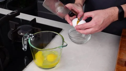 Chef man hands cooking Omelette, break eggs into a bowl Stock Footage 260233617