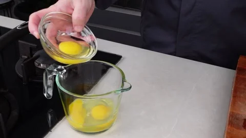 Chef man hands cooking Omelette and whisking eggs Stock Footage 260233621