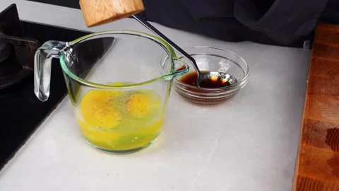 Chef man hands cooking Omelette and whisking eggs with sauce Stock Footage 260234175