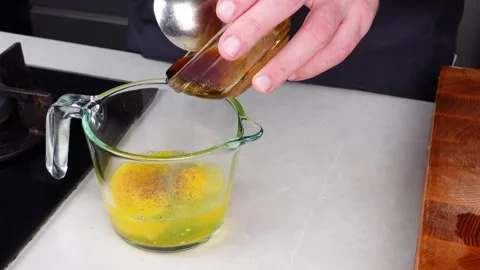 Chef man hands cooking Omelette and whisking eggs with sauce Stock Footage 260234432