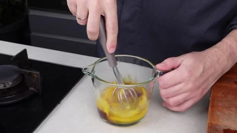 Chef man hands cooking Omelette and whisking eggs with sauce Stock Footage 260234433
