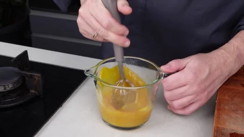 Chef man hands cooking Omelette and whisking eggs with sauce Stock Footage 260234435