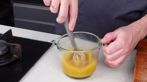 Chef man hands cooking Omelette and whisking eggs with sauce Stock Footage 260234517