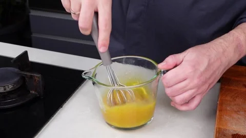 Chef man hands cooking Omelette and whisking eggs with sauce Stock Footage 260234528