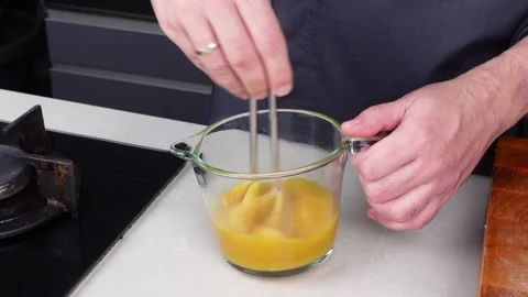 Chef man hands cooking Omelette and whisking eggs with sauce Stock Footage 260234530