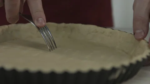 Chef Man Piercing Dough in Baking Pan with Fork Stock Footage 160964008