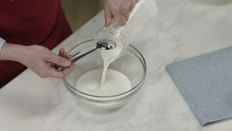 Chef Man Pouring Milk or Liquid Cream from Graffin Stock Footage 164019357