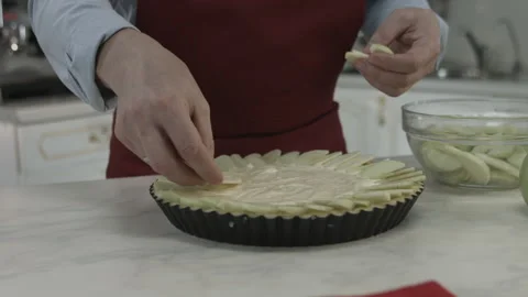 Chef Man Putting Apple Pieces on Pie in Kitchen Stock Footage 160977912
