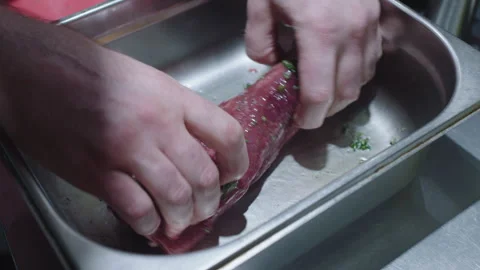 Chef marinating a piece of meat Stock Footage 283013809
