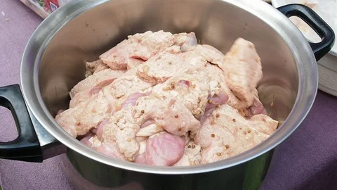 The chef is marinating pieces of pork udder with seasonings and spices. Stock Footage 101143902