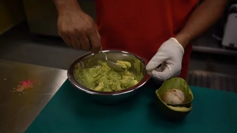 Chef mashing avacado with fork Stock Footage 229532204