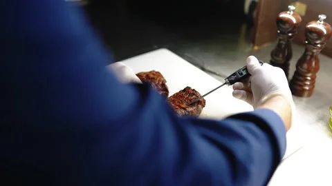 Chef measures the temperature of the meat. Stock Footage 145855696