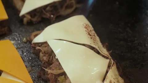 Chef Melting Provolone Cheese over Savory Shredded Beef with a Blowtorch Stock Footage 331636647