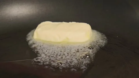 Chef Melts Down A Piace Of Diary Butter On A Frying Pan To Fry Food Stock Footage 157991377