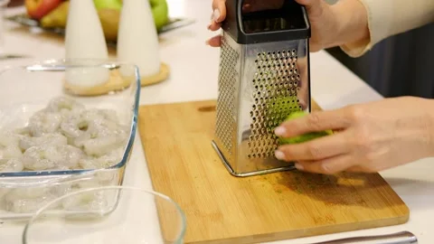 Chef meticulously grates lime zest to elevate meat flavor. Fragrant lime essence Stock Footage 270715940