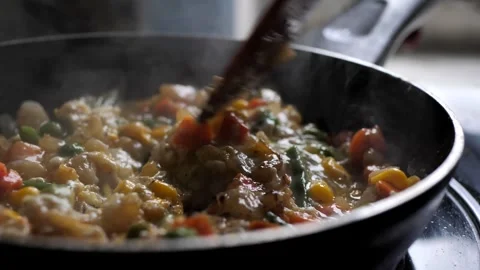 The chef mixes chicken eggs with vegetables in a frying pan. mixed colorful Stock Footage 263492163