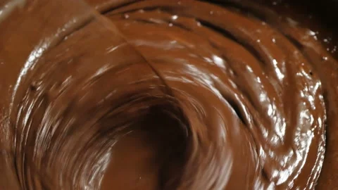 The chef mixes the chocolate with a blender, preparing the ingredients for the Stock Footage 150905870