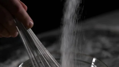 Chef mixes the eggs with the sugar black background Stock Footage 69919622