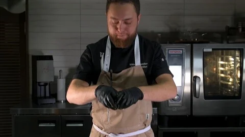 The chef mixes fish with Greens Stock Footage 97880896