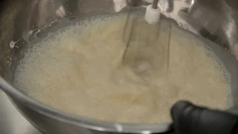 The chef mixes the mixture in a cooking vessel Stock Footage 137828004