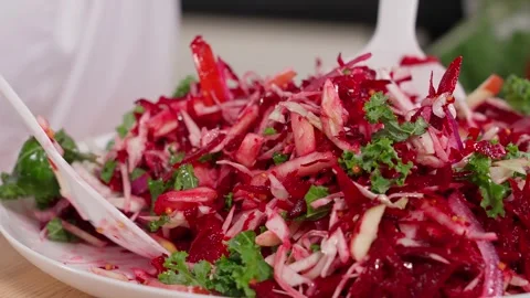The chef mixes a salad of beets, apples, kale, and onions Stock Footage 265177477