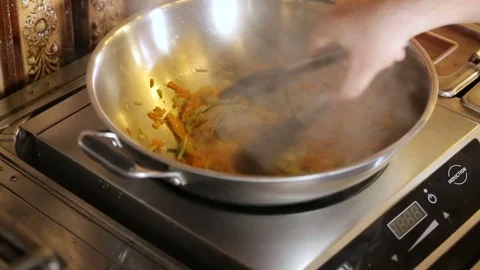 Chef Mixes vegetable Pasta in pan Stock Footage 74716145