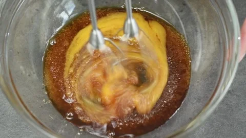 The chef mixing egg yolks, brown sugar and Marsala wine with electric mixer. Stock Footage 170903023