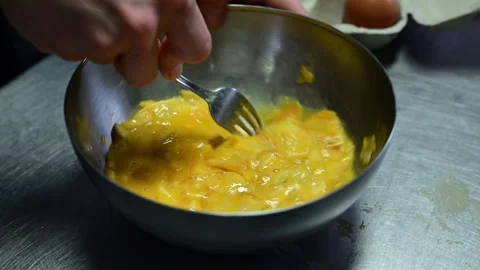 Chef mixing eggs and fried potatoes for spanish omelette Stock Footage 330428553