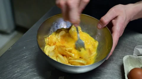 Chef mixing eggs and fried potatoes for spanish omelette Video stock 330428592
