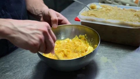 Chef mixing eggs and fried potatoes for spanish omelette Video stock 330428606