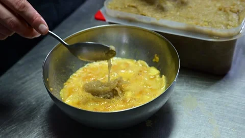 Chef mixing eggs and fried potatoes for spanish omelette Stock-Footage 330428615
