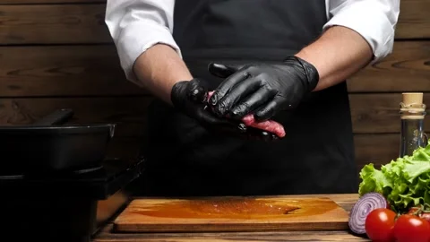 Chef mixing ground beef and shaping a burger patty Video stock 197388156