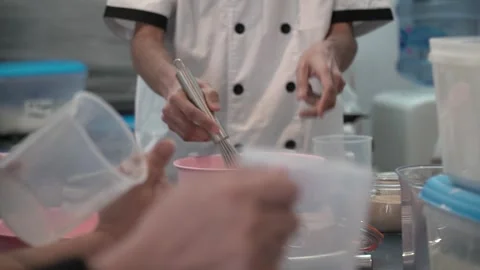 Chef Mixing Ingredients in Kitchen Stock Footage 317472390