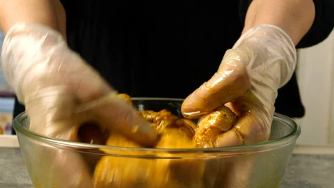 Chef mixing raw chicken legs for barbecue or frying. Stock Footage 131368064