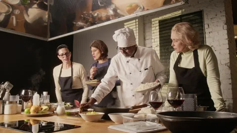Chef Mixing Rice with Meat in Pan During Group Cooking Master Class Stock Footage 332573864