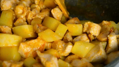 Chef mixing stirring chicken and potatoes cooking in frying pan on kitchen. Stock Footage 312469231