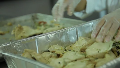 Chef. Moving cooked chicken to container B Stock Footage 101701223
