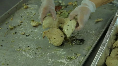 Chef. Moving cooked chicken to container A Stock Footage 102184978