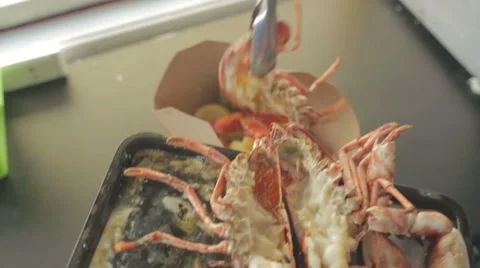 Chef moving serving up lobster from grill to plate Stock Footage 58431732