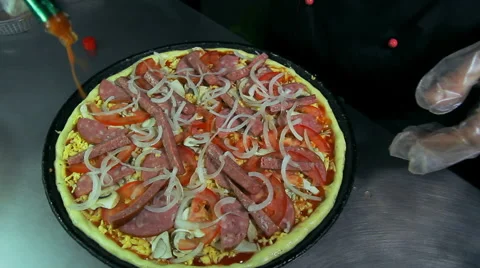 Chef napping baked pizza with tabasco sauce Stock Footage 41937869