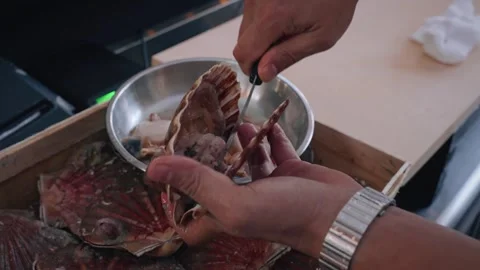 Chef opening scallops overhead 4K video Stock Footage 317456878